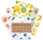 Six Aitoper Swedish dishcloths with various fruit patterns, neatly stacked or fanned out on a kitchen counter.