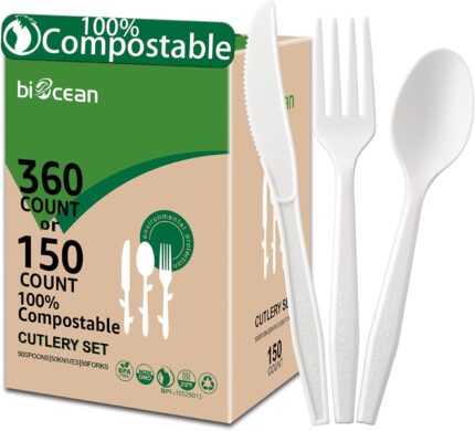 A complete set of ivory white biocean compostable forks, spoons, and knives neatly arranged, showcasing their heavy-duty, pla