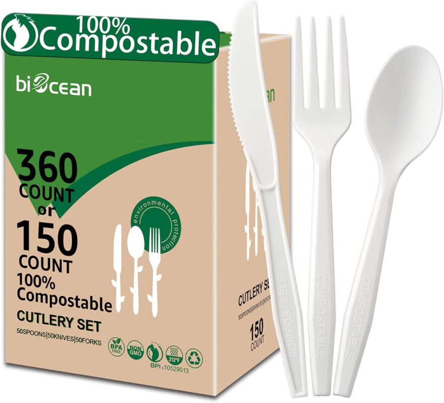 A complete set of ivory white biocean compostable forks, spoons, and knives neatly arranged, showcasing their heavy-duty, pla