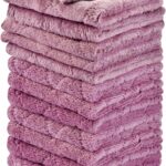 A stack of 12 purple coral fleece kitchen towels, neatly folded, showcasing their soft texture and rectangular shape.