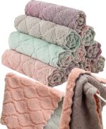 A stack of 12 coral velvet kitchen towels, neatly folded, showcasing their soft texture and absorbent material.