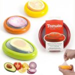 Set of colorful silicone food pods in green, red, yellow, and brown, holding various fruits and vegetables.