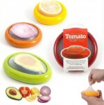 Set of colorful silicone food pods in green, red, yellow, and brown, holding various fruits and vegetables.