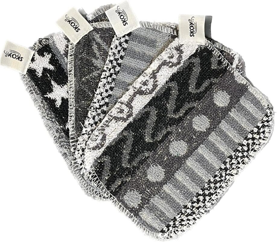 Four monochromatic Skoy Scrubs, round and flat, arranged neatly to showcase their texture and colors.