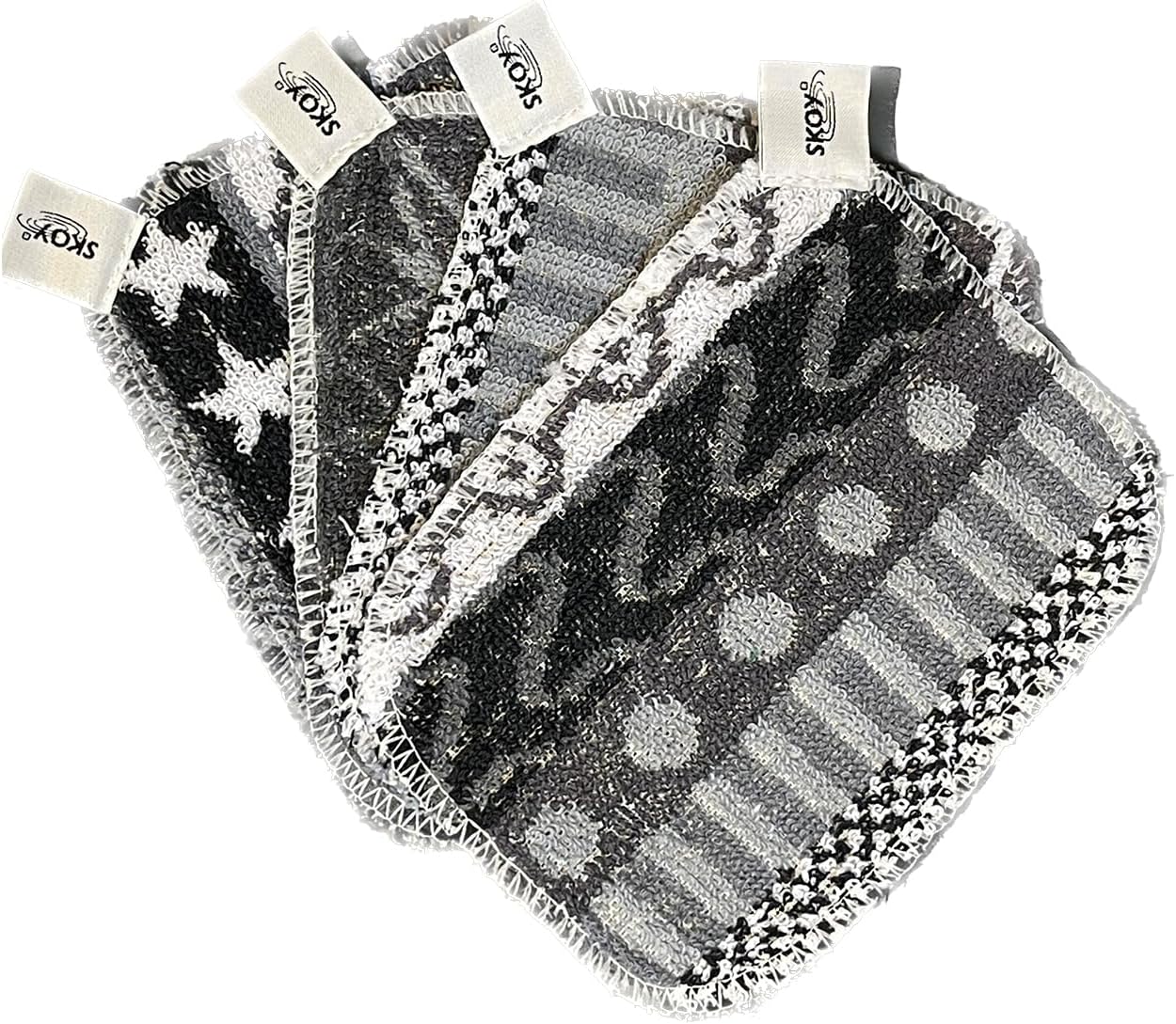 skoy-scrub-4-pack-reusable-non-scratching-dish-scrubber-for-kitchen-01 Four monochromatic Skoy Scrubs, round and flat, arranged neatly to showcase their texture and colors.