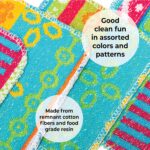 Four assorted color Skoy Scrubs, round with various patterns, arranged on a clean kitchen counter next to a sink.